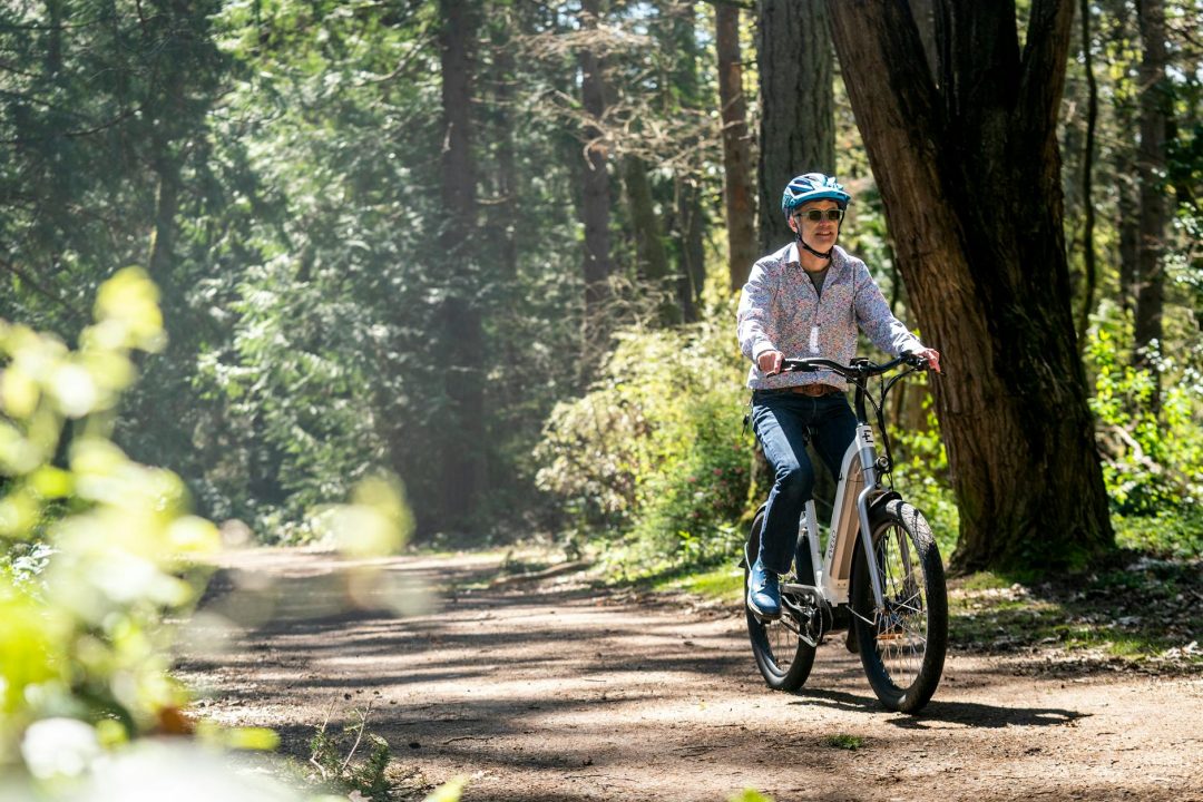 man riding bicycle in the forest